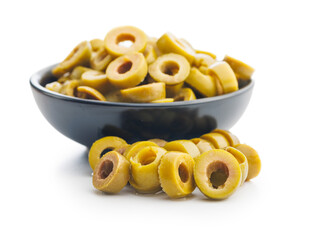 Poster - Sliced pickled green olives in brine in bowl isolated on white background.