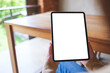 © Farknot Architect - Mockup image of a woman holding digital tablet with blank white desktop screen