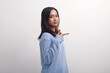 © adipurnatama - Side view of Asian girl pointing finger to her side