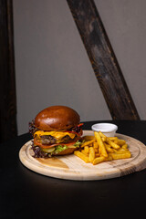 Wall Mural - A delicious hamburger on a dark background.