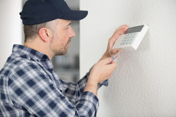 an electrician installing alarm system