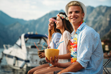 Wall Mural - Happy friends having fun with tropical cocktails on beach party. Travel and summer vacation concept.