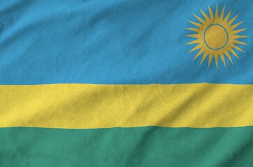 Canvas Print - Rwanda flag depicted on folded wavy fabric of old cloth close up