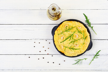 Wall Mural - Fried omelette in a pan. Breakfast with scrambled eggs