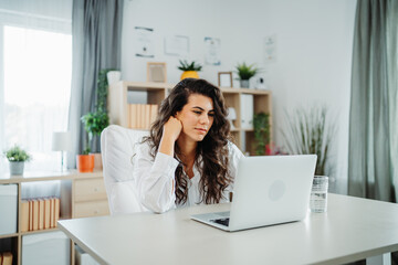 Wall Mural - Young caucasian business woman working in office on laptop 