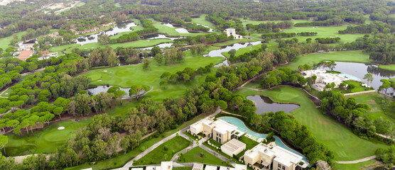 Wall Mural - Aerial view of golf course and luxury villas in Belek, Turkey. Scenic panoramic view of golf fairway