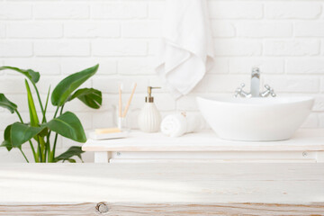 Wall Mural - blurred bathroom interior background with empty wooden table top for product montage