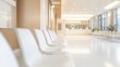 © Aamir - Modern hospital waiting room with white chairs on a blurred background, clean and simple seating areas, patient waiting spaces, healthcare facility