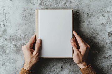 Poster - This mockup shows a man holding a brochure with a blank cover against a grey background.