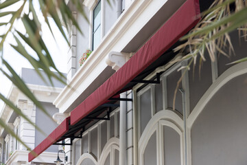 Poster - A red awning is hanging over a building