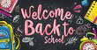 © Alina Zavhorodnii - School backpacks on the background of dark school blackboard with the words welcome to school