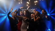 © wedmoments.stock - Happy friends at a party enjoying themselves, taking photos with a smartphone, and sharing their weekend lifestyle on social media. A vibrant scene perfect for showcasing social fun and modern connect