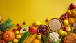 © Tarom - Various fruits and vegetables are placed on a bright yellow smooth textured background and space for text 2