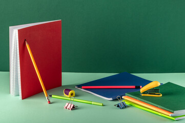 Wall Mural - School stationery on green background with copy space. Pencils and notebooks. Workplace organization.organization.