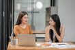 © aekachai - Asian business woman Discussing business documents in the office