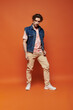 © LIGHTFIELD STUDIOS - A stylish man expresses emotions with a vibrant backdrop enhancing his presence.