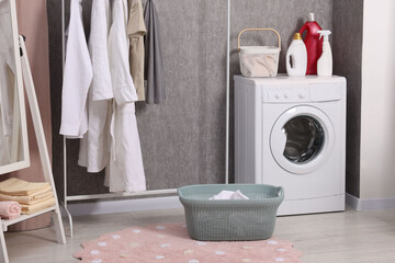 Canvas Print - Washing machine, detergents, baskets, clothing rack and mirror indoors