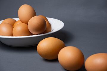 White plate with arrangement of raw chicken eggs. Raw chicken eggs for cooking purposes.