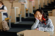 © Seventyfour - Portrait of bored young Asian female student at desk leaning on hand looking away while attending lecture class at university, copy space