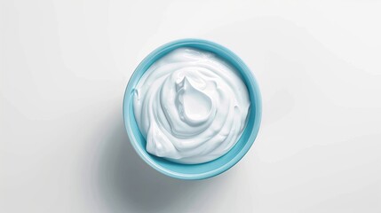 Blue ceramic bowl of fresh Greek yogurt or sour cream isolated on white background top view