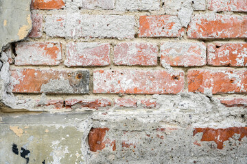 Wall Mural - old masonry wall made of red bricks with crumbled plaster as full frame background structure for arc