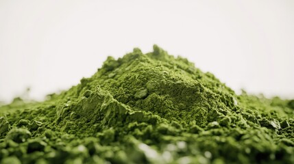 Macro low-angle of a vivid green matcha powder mound, white backdrop, detailed focus, soft natural light.