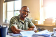 © Garnar - African American man veteran smiling while discussing finances in well-lit room. Concept of rehabilitation military veterans and social integration through financial planning and consultation services