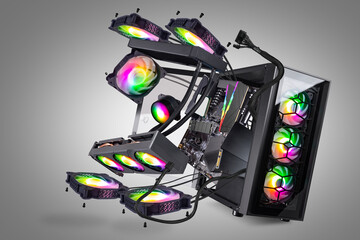 Fototapete - Black modern high end gaming computer with glass windows and bright colorful rainbow RGB LED lights grey background. flying parts and components pc in exploded view.