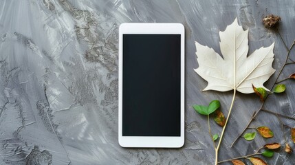 Poster - White tablet and white leaf on gray backdrop flat lay copy space