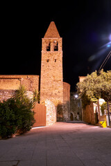 Wall Mural - Street with houses and a church bell tower during the night in Magliano in Toscana