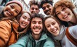 © Myimages - Multicultural group of young people smiling together at camera - Happy friends taking selfie pic with smartphone outdoors