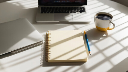 a desk with a laptop and a notebook and cup of coffee, isolated background for text