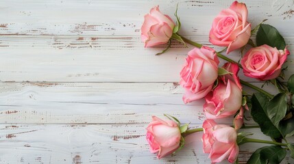 Canvas Print - Pink roses on white wooden table in close up background viewed from top with space for text