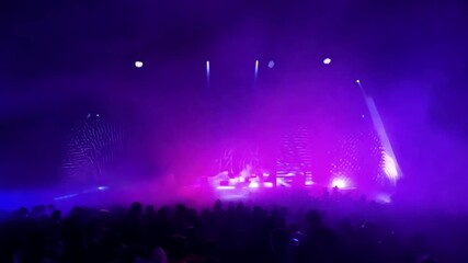 Poster - Colorful beams of light illuminate a lively concert, where the crowd is energized and engaged, creating an electrifying atmosphere.