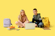 © Pixel-Shot - Cute pupils with laptop, backpacks and books on yellow background