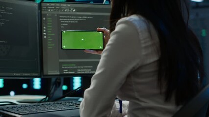 Poster - zoom in on green screen mobile phone used by data center employee troubleshooting issues. engineer u