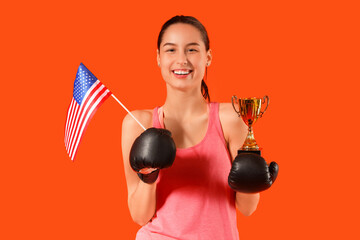 Wall Mural - Female boxer with gold cup and USA flag on orange background