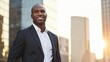 © Adriana - Happy wealthy rich successful black businessman standing in big city modern skyscrapers street on sunset thinking of successful vision, dreaming of new investment opportunities.