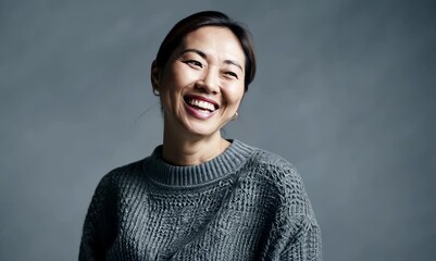 Sticker - portrait of a smiling asian woman in sweater on grey background