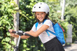 © Pixel-Shot - Cute schoolgirl in helmet riding electric scooter outdoors