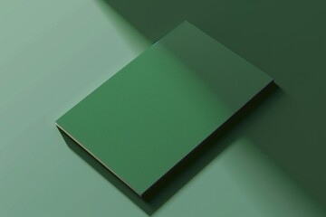 Wall Mural - A closed green book sits on a flat surface, possibly a desk or table