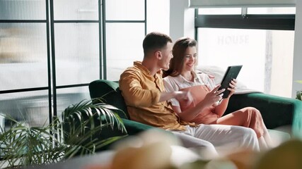 Poster - Couple, tablet and bonding on sofa in home networking on social media, digital app or internet. Man, woman and browse with comic, funny joke or online meme with technology in living room at house