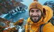 © Igal - A delighted male traveler is capturing a selfie on top of a mountain, a travel blogger smiling at the camera while taking a self-portrait with his smart mobile phone, blending travel and technology.