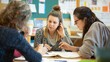 © Super - A group of teachers planning lessons together, sharing ideas and resources, dedicated and cooperative