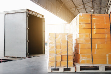 Wall Mural - Bulk Pallets of Packaging Boxes Being Loaded onto a Container Trucks. Distribution Warehouse Container Transport, Supply chain, Parcel Delivery. Freight truck, Logistics, Transportation.