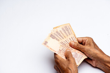 Counting Indian paper currency on isolated on white background