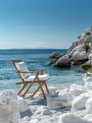 Wall Mural - A chair on a white rock on the beach, Greece, has a clear blue sky and the Mediterranean Sea