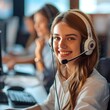 © Ameer - Smiling female customer support operator wearing headset engaged in professional communication with colleagues in a modern office environment