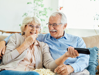 Wall Mural - television watching senior couple tv home woman man remote movie mature old aged active vitality eld