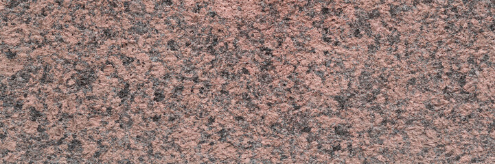Wall Mural - Granite texture. Natural pink granite with a grainy pattern. Stone background. Solid rough surface of rock. Durable construction and decoration material. Close-up.